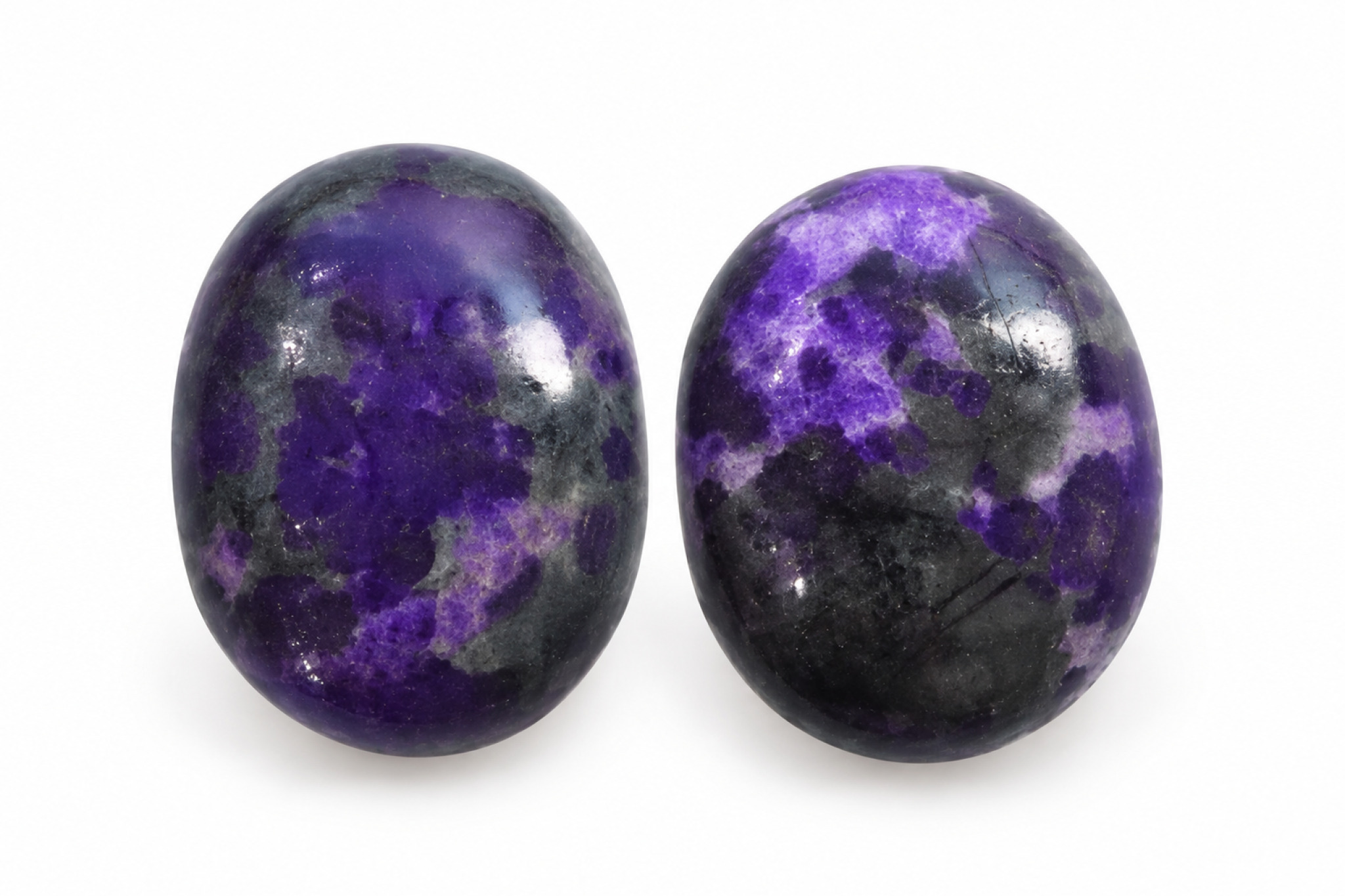 Polished Sugilite cabochons showing natural purple color variation
