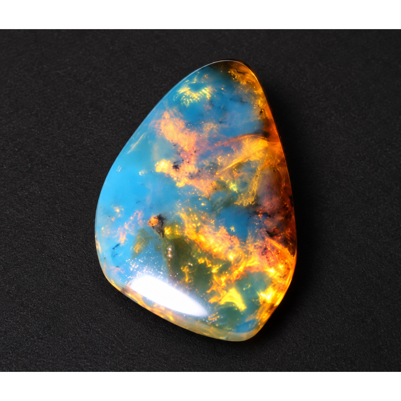 Nature created orange blue Dominican amber cabochon